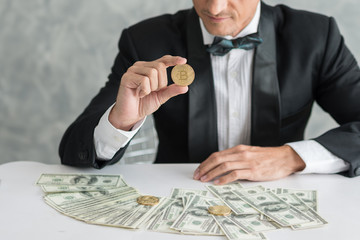 Young businessmen who are successful in business, Show Coin Bitcoin and many banknote dollars money at office desk. business success concept