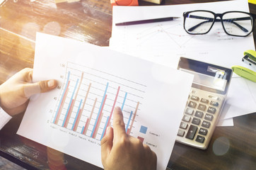 Businessmen use the calculator to calculate and analyze the comp