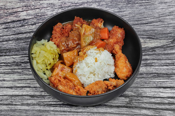 Rice with deep fried chicken,sliced picklesl topped Japanese yellow curry .