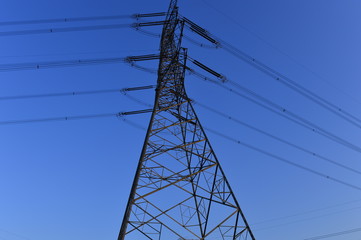 The silhouette of the evening electricity transmission pylon