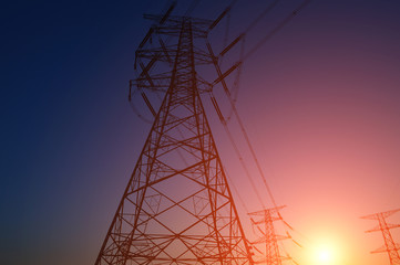 The silhouette of the evening electricity transmission pylon