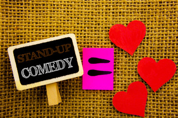 Writing text showing  Stand Up Comedy. Concept meaning Entertainment Club Fun Show Comedian Night written on blackboard equation Meaning Love Heart on the textured background