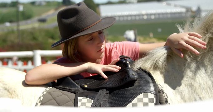 Girl petting a horse in the ranch 