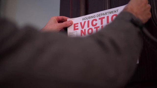 Man Places House Eviction Notice Sign For Repossession, Bank Home Mortgage Or Rent Debt 4K