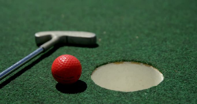 Golf putter and golf ball on a artificial turf 