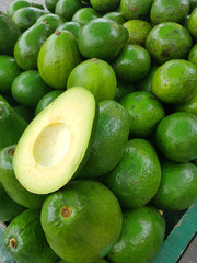 a lot or a pile of avocados in a local market in Bogota, Colombia