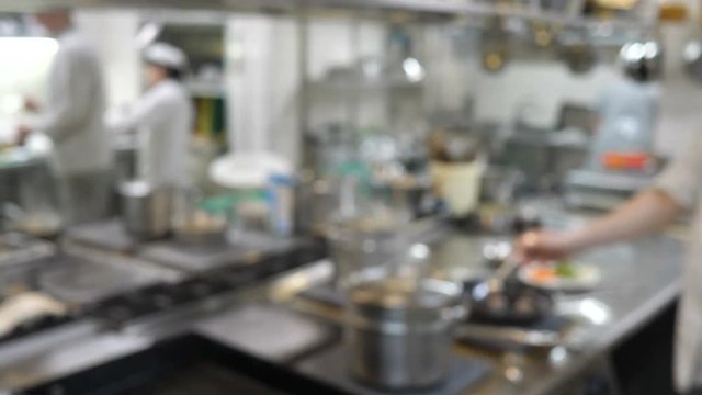 Blurred background : Groups of Chef cooking in the open kitchen,customer can see they cooking at food counter, cooking chef with light bokeh