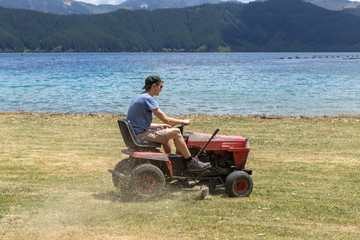 Man cutting grass with a lawn mower