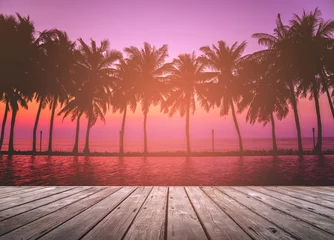Blackout curtains Tropical beach Empty wooden terrace over tropical island beach with coconut palm at sunset or sunrise time