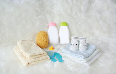 Obraz na płótnie Canvas Children's bath products and hygiene items on white fur.
