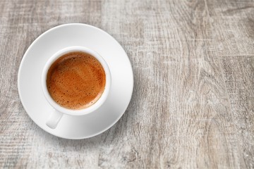 Coffee cup on wooden desk