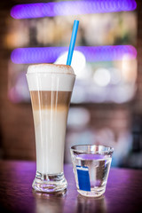 Coffee. Hot coffee. Coffee beans. Wooden table. Blurred background