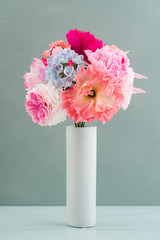 Crepe paper flower bouquet with peonies, hyacinth, garden rose and poppies in a vase