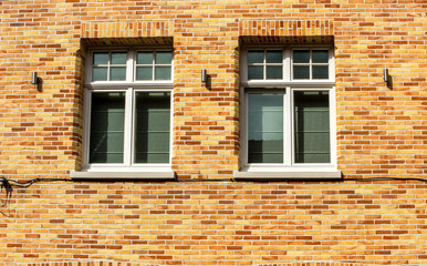 Two white windows against a green wall in the city of Brugge, Belgium, Europe