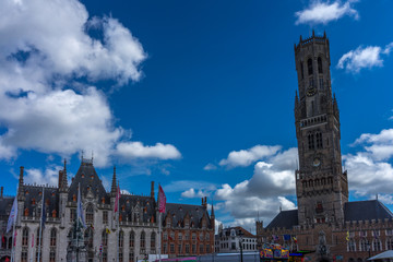 Fototapeta na wymiar The old city hall along with the Belfry tower in the Markt square in Bruges, Belgium, Europe
