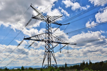High voltage electricity pylon against cloud