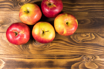 Red apples on wooden table. Top view, copy space