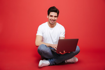 Portrait of a happy young man in white t-shirt