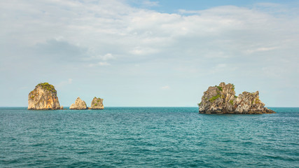 Four of hundreds small uninhabited karst rocky islands with green flora on top. Andaman sea between...
