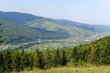 Landscape village between mountains and forest
