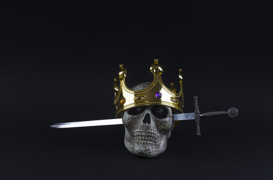 crown, sword and skull on a black background