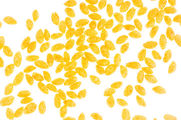 Puffy orange corn sticks with chili isolated on white background, top view, pattern. Fast food background.