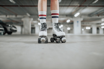 young sexy woman rollerskating in an urban looking garage and posing in a hipster like matter