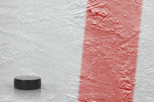 Puck and fragment of the ice arena with a red line