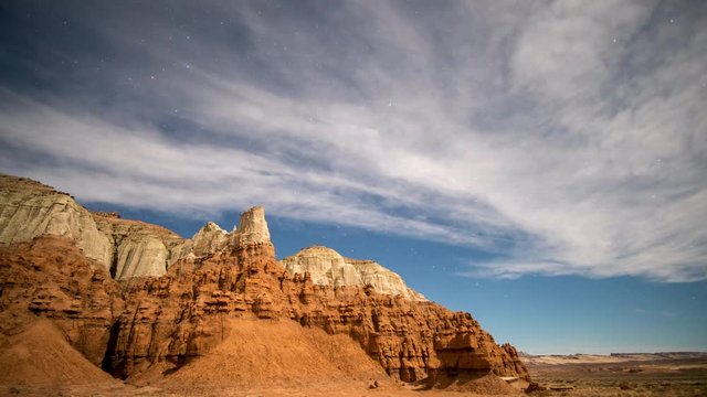 Night time lapse in Goblin Valley with full moon lighting up the landscape.