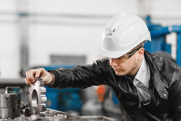 factory engineer checks the quality of the manufactured part