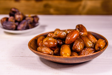Date fruits on the white wooden table