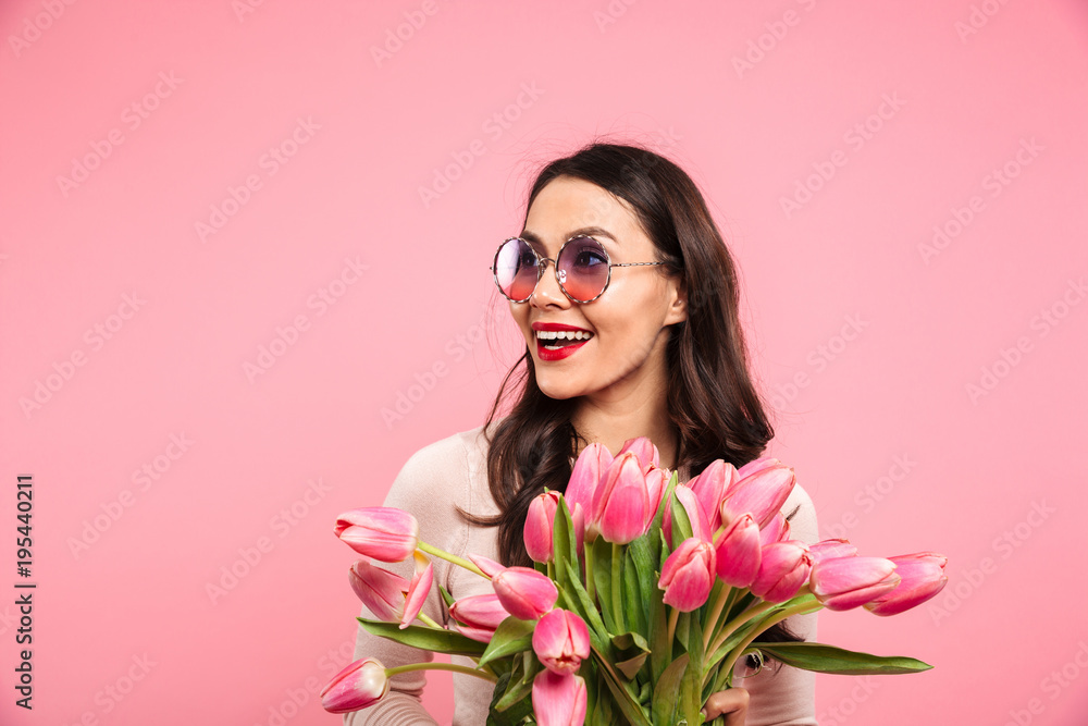 Poster photo of gorgeous adult girl with long dark hair in round glasses holding amazing bunch of blossom t