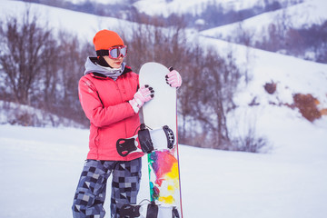 Fototapeta na wymiar woman snowboarder skiing on the snow-covered slope