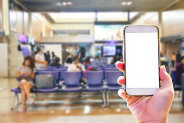 People hand use cellphone at the hall airport background with copy space on screen for using mobile app about activities in the airport or checking flight plan