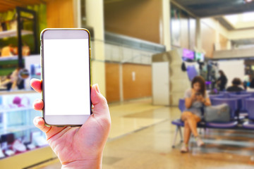 People hand use cellphone at the hall airport background with copy space on screen for using mobile app about activities in the airport or checking flight plan