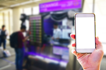 People hand use cellphone at the hall airport background with copy space on screen for using mobile app about activities in the airport or checking flight plan