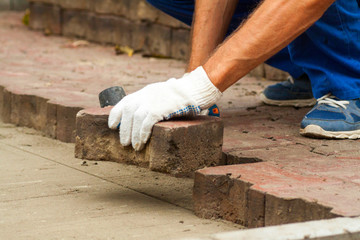 laying paving slabs on city square, repairing