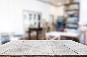 Selected focus empty brown wooden table and Coffee shop or restaurant blur background with bokeh image. for your photomontage or product display.