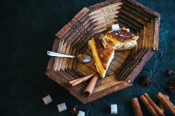 Cake on a wooden tray on a black matte background