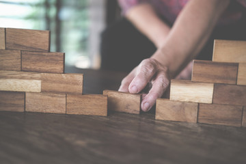 hand stacking wood block. growth, success & development in business