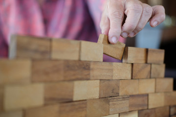 hand stacking wood block. growth, success & development in business