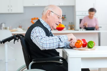 Acrylic kitchen splashbacks Cooking senior couple cooking together - man disabled on wheelchair