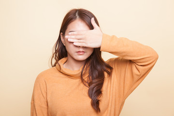 Fototapeta premium Young Asian woman close her eyes with hand.