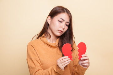 Beautiful young Asian woman with broken heart.