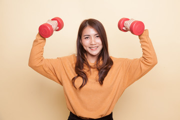 Healthy Asian woman with dumbbells.