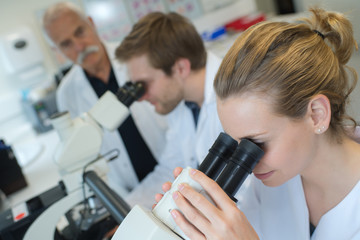 doctors working in the lab with microscope