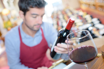 sommelier looking through glass of wine checking quality