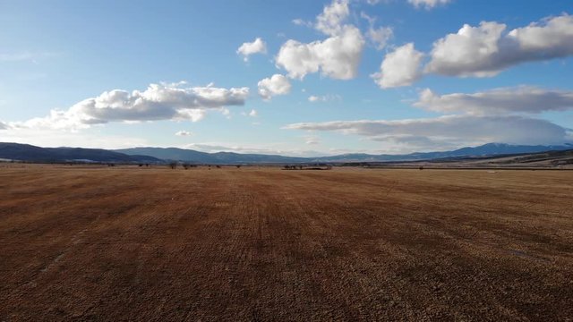 Aerial view in agriculture field at sunset in rural Bulgaria 4K UHD.