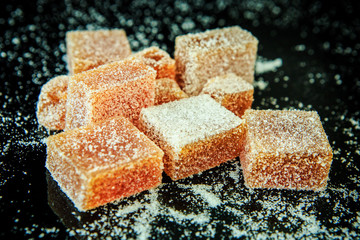 tasty marmalade on black mirror background