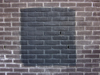 black square on a brick stone wall